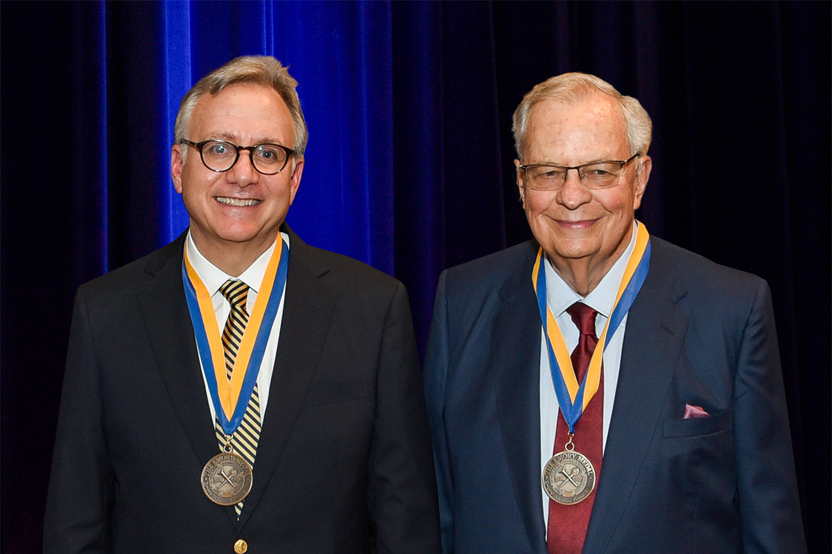 David Adelman and Richard Hubert are shown with their Emory medals hanging from blue and yellow ribbons around their necks.