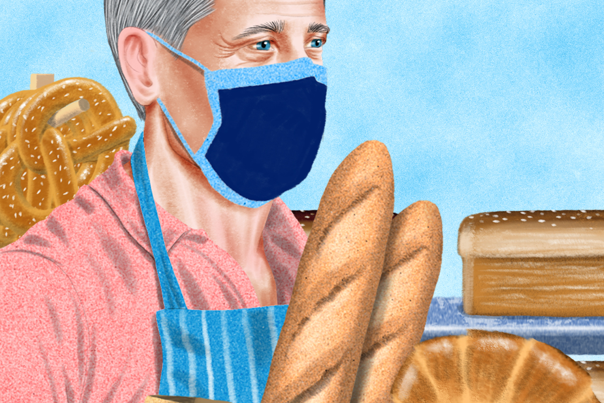 Illustration of a baker in the kitchen, surrounded by bread, and wearing a face-covering.