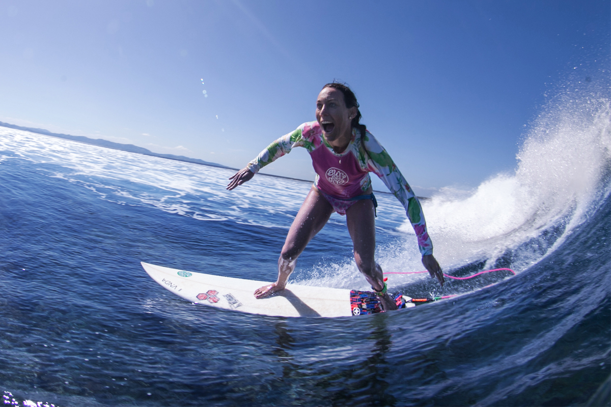 photo of alumna Shelby Stanger surfing waves