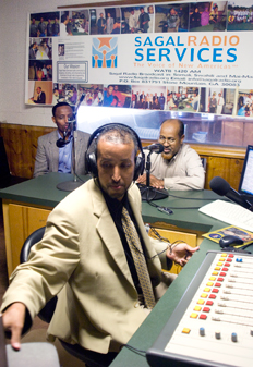 Hussien Mohamed (back left) director of HEARMe, with Abdulkadir Sagaar (front center) and Omar Mohamed (back right) in the Sagal Radio studio in Clarkston, Georgia.