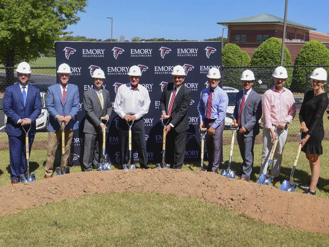 Photo of people holding shovels at a groundbreaking