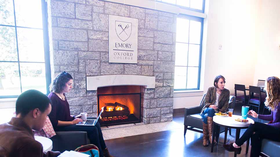 students sitting by fireplace in dining hall