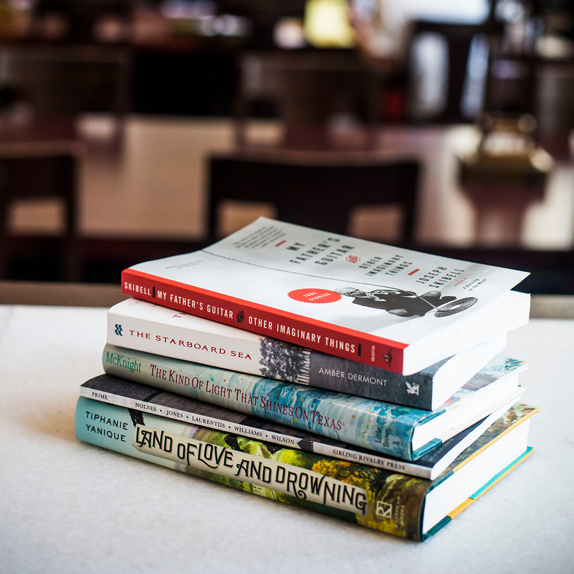 a stack of colorful books on a table