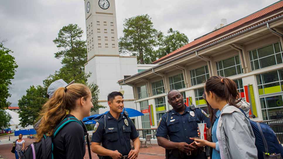 police talk to student on walkway