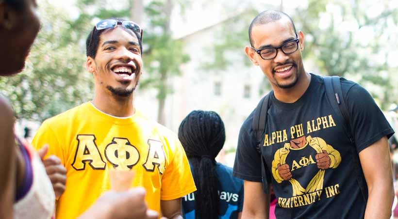 students wearing fraternity tshirts