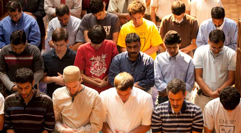 students sitting in pews praying