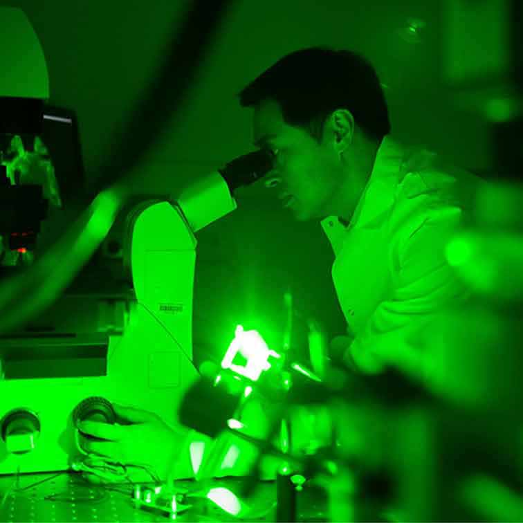 Researcher Hee Cheol Cho looking into a microscope