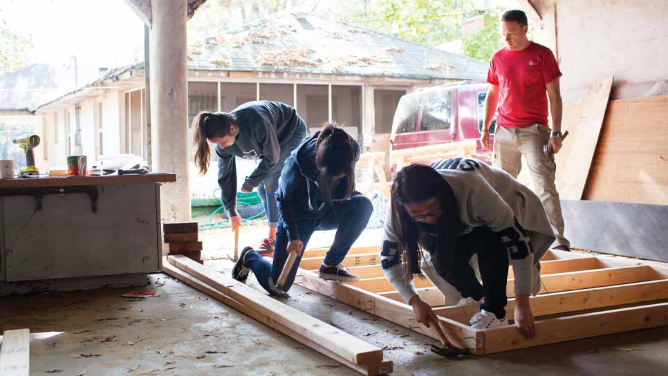 students building and volunteering
